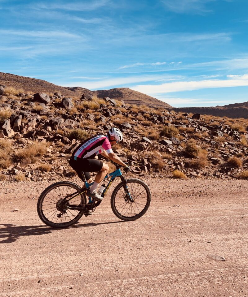 Cyclists riding through the High Atlas Mountains on a multi-day cycling tour from Marrakech to Ouarzazate, passing valleys, kasbahs, and scenic desert landscapes - High Atlas cycling tour